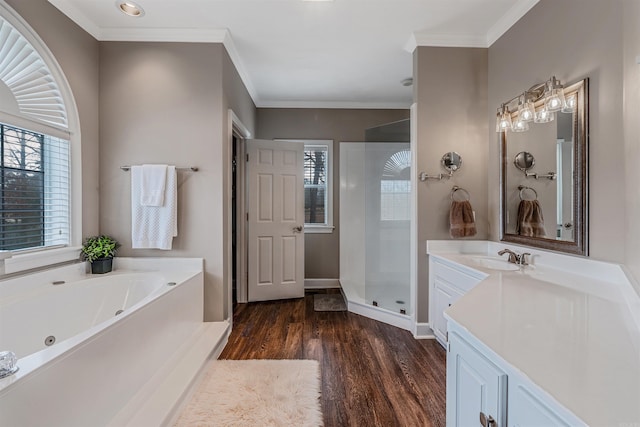 bathroom featuring crown molding, a shower stall, vanity, wood finished floors, and a bath