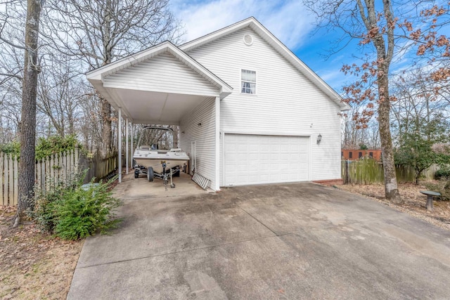 view of property exterior featuring concrete driveway and fence