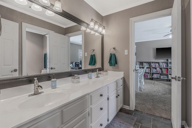 full bath with double vanity, ornamental molding, a sink, and a ceiling fan