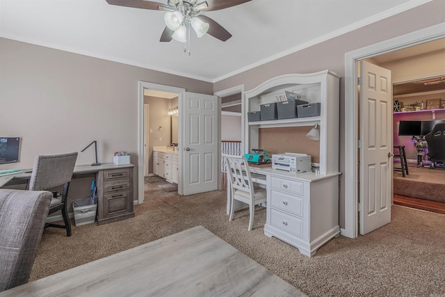 home office with light carpet, ceiling fan, and crown molding