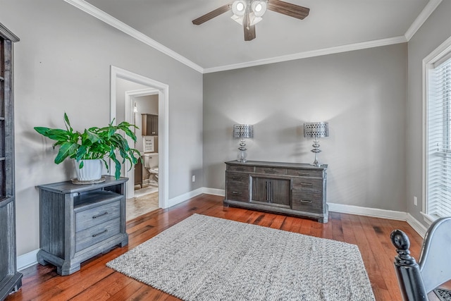 living area featuring ornamental molding, dark wood-style flooring, a ceiling fan, and baseboards