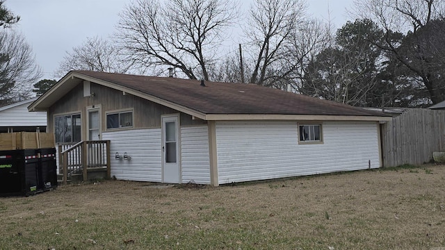 view of outbuilding featuring fence