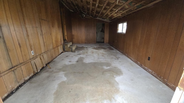 below grade area with a garage and wooden walls