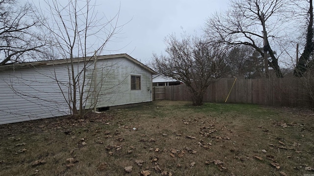 view of home's exterior with a yard and fence