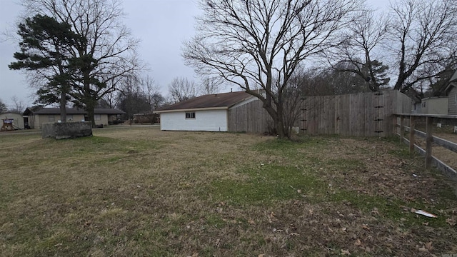 view of yard with fence and an outdoor structure