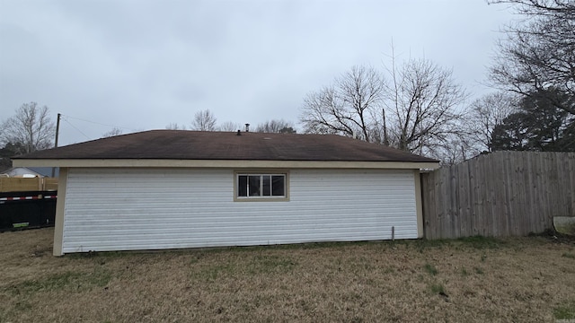 view of property exterior featuring fence and a yard