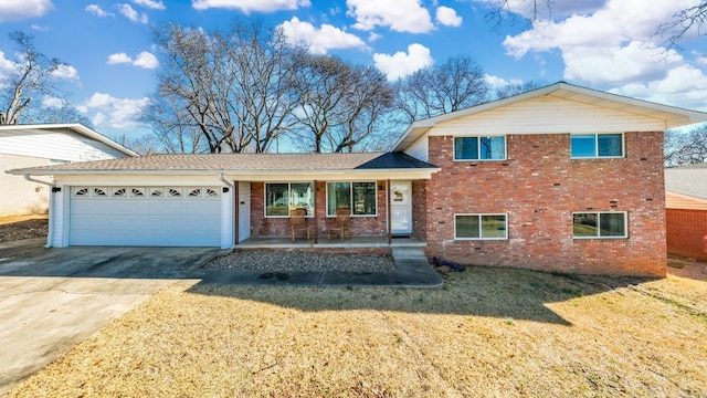 3612 Pope Ave, North Little Rock, AR 72116 - split level home featuring a porch, an attached garage, brick siding, driveway, and a front lawn