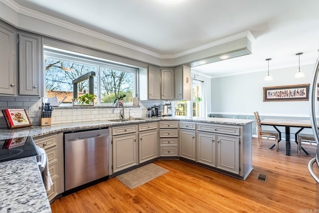 kitchen with a peninsula, visible vents, hanging light fixtures, light stone countertops, and dishwasher