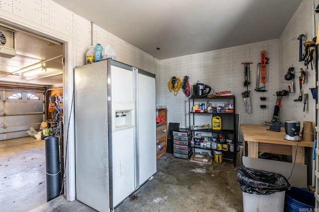 interior space featuring a garage, concrete floors, and a workshop area