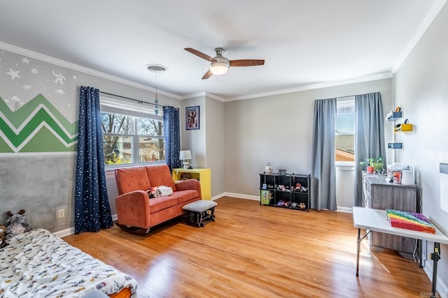 sitting room with visible vents, wallpapered walls, baseboards, and wood finished floors