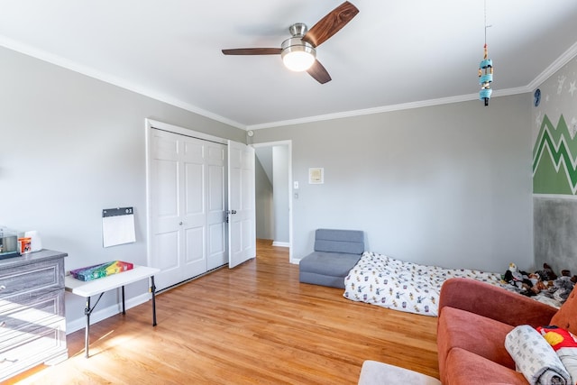 living area with ornamental molding, ceiling fan, baseboards, and wood finished floors