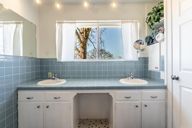 bathroom featuring double vanity, tile walls, and a sink