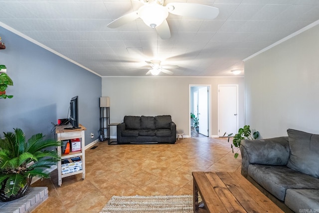 living room with baseboards, ornamental molding, and a ceiling fan