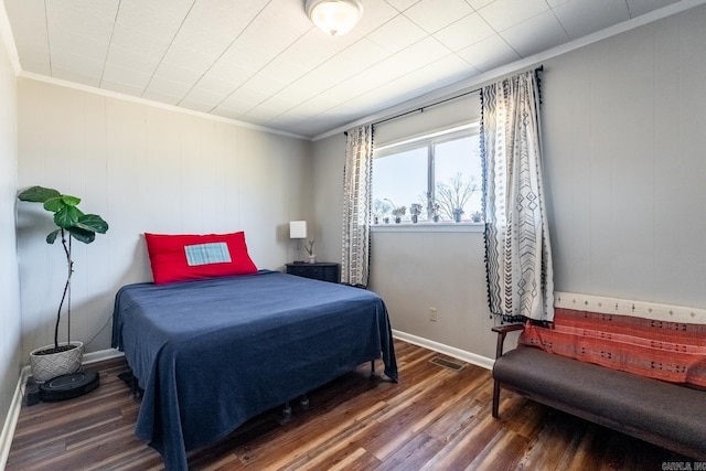 bedroom featuring baseboards, crown molding, visible vents, and dark wood-type flooring