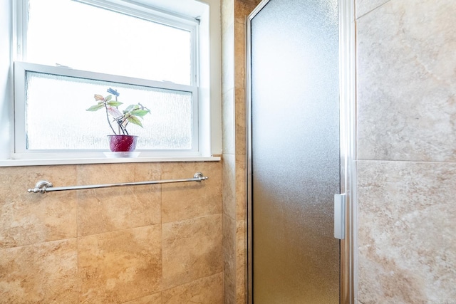 interior details featuring a tile shower