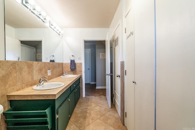 bathroom with double vanity, tile patterned flooring, decorative backsplash, and a sink