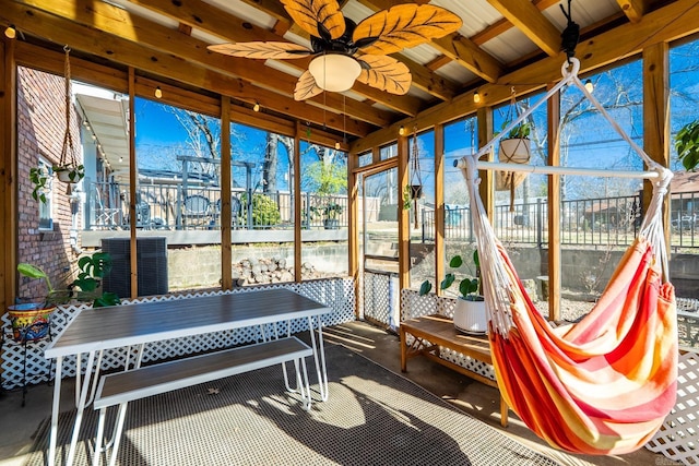 sunroom with a wealth of natural light and ceiling fan