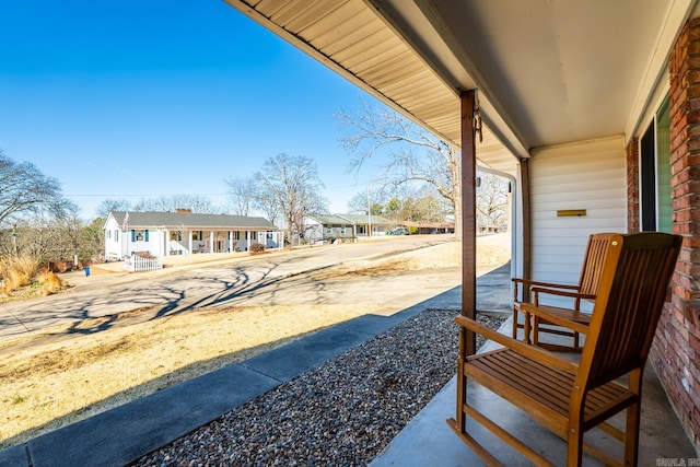 view of patio / terrace featuring a residential view and a porch