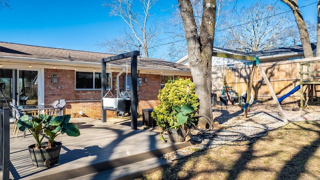 exterior space featuring fence and a deck