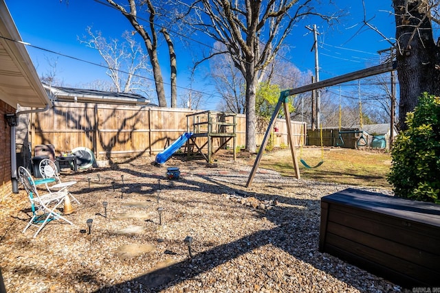 view of yard with a playground and a fenced backyard