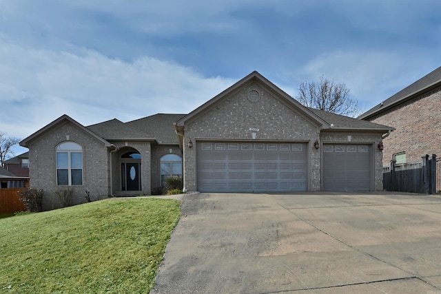 ranch-style house with a garage, brick siding, fence, driveway, and a front yard