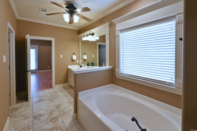 bathroom featuring visible vents, baseboards, vanity, a tub with jets, and crown molding