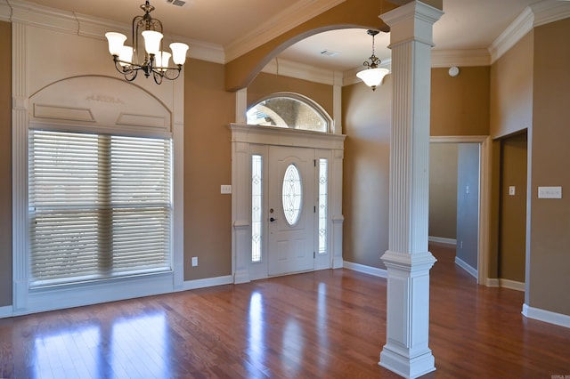 entrance foyer with wood finished floors, crown molding, baseboards, and decorative columns