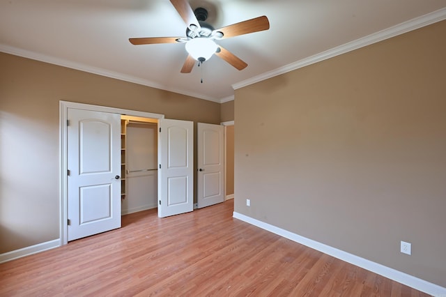 unfurnished bedroom with a ceiling fan, baseboards, ornamental molding, a closet, and light wood-type flooring