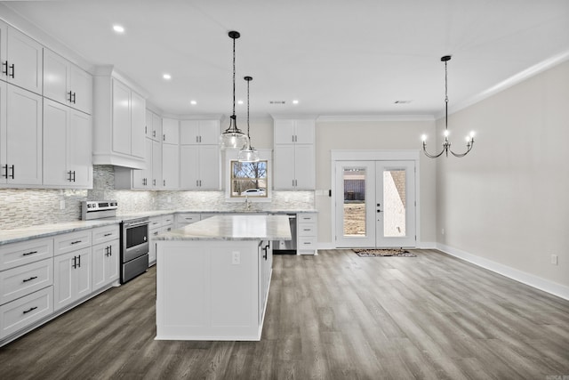 kitchen with a kitchen island, appliances with stainless steel finishes, and white cabinets