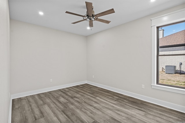 empty room featuring dark wood-style floors, ceiling fan, baseboards, and recessed lighting