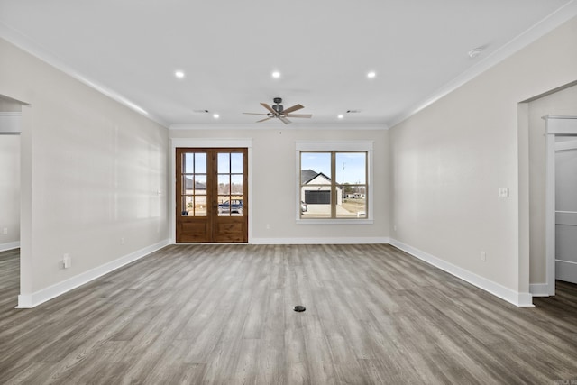 unfurnished living room featuring french doors, recessed lighting, light wood-style flooring, ornamental molding, and baseboards