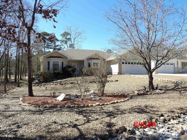 ranch-style home with a garage and driveway