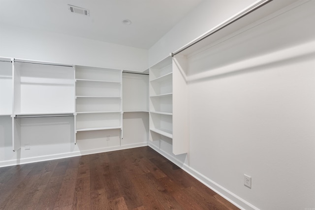 spacious closet featuring visible vents and dark wood finished floors