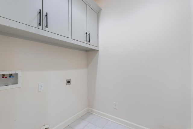 laundry area featuring washer hookup, cabinet space, electric dryer hookup, and baseboards