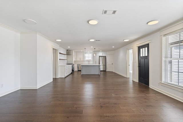 unfurnished living room with dark wood-type flooring, recessed lighting, visible vents, and baseboards