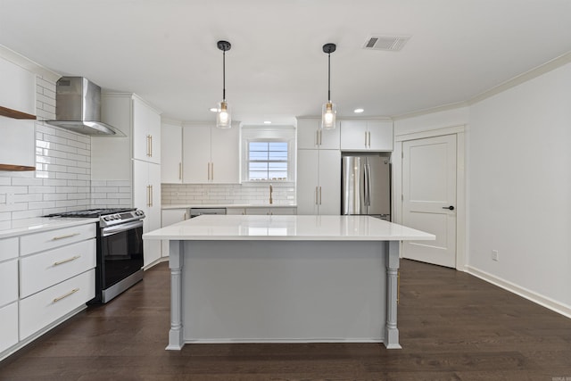 kitchen with visible vents, appliances with stainless steel finishes, light countertops, wall chimney range hood, and open shelves