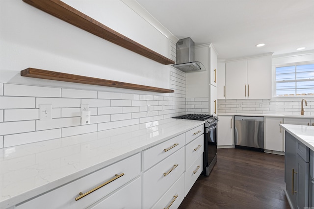 kitchen featuring stainless steel appliances, white cabinetry, wall chimney range hood, dark wood-style floors, and open shelves