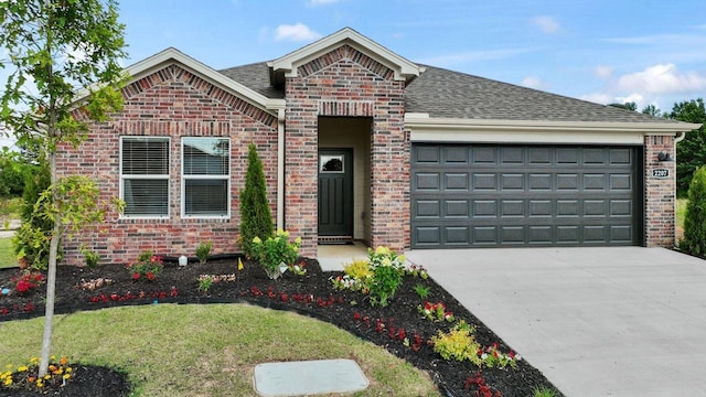 view of front of home with driveway, brick siding, roof with shingles, and an attached garage