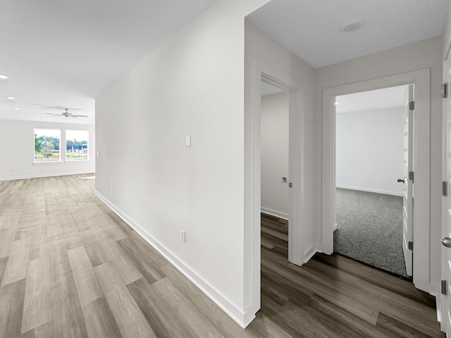 hall with wood finished floors and baseboards