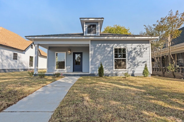 view of front of property featuring covered porch and a front yard