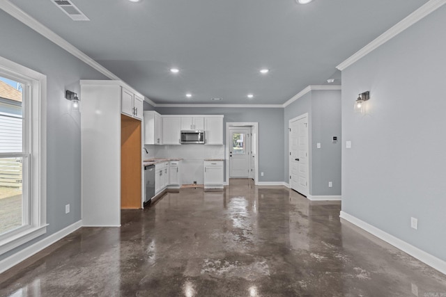 kitchen featuring baseboards, stainless steel appliances, a wealth of natural light, and white cabinets