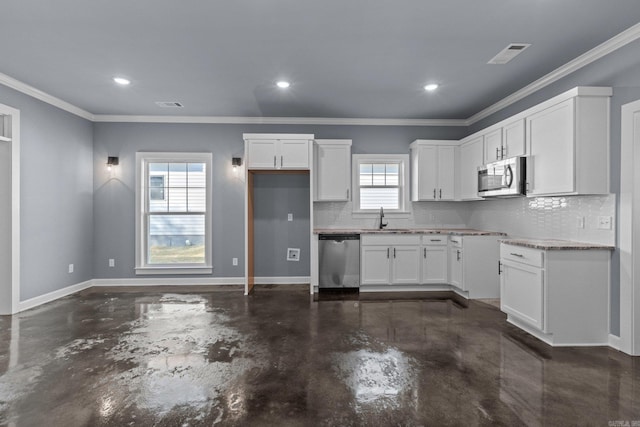 kitchen featuring visible vents, stainless steel appliances, white cabinetry, and baseboards