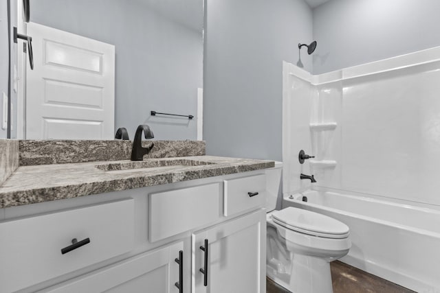 bathroom with shower / washtub combination, vanity, and toilet