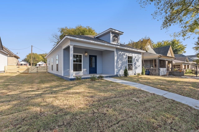 view of front of house featuring a porch, a front yard, and fence