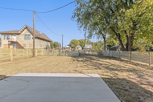 view of yard with a fenced backyard and a patio