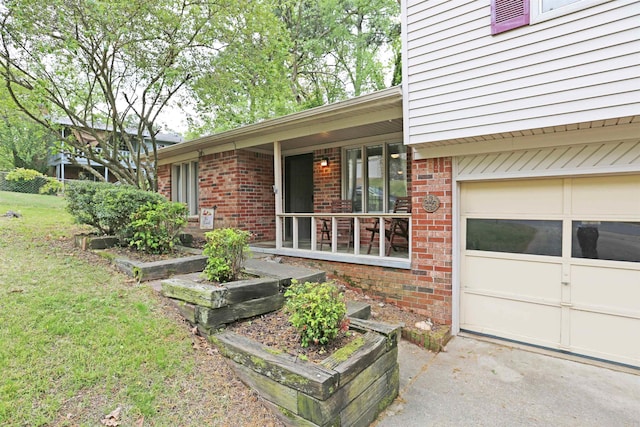 property entrance with covered porch, a yard, and brick siding