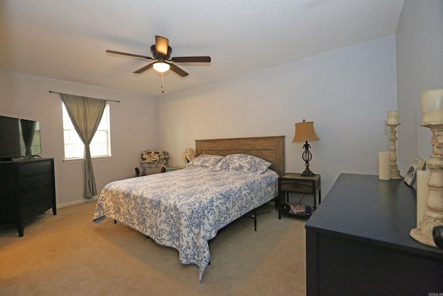 bedroom with light carpet and a ceiling fan