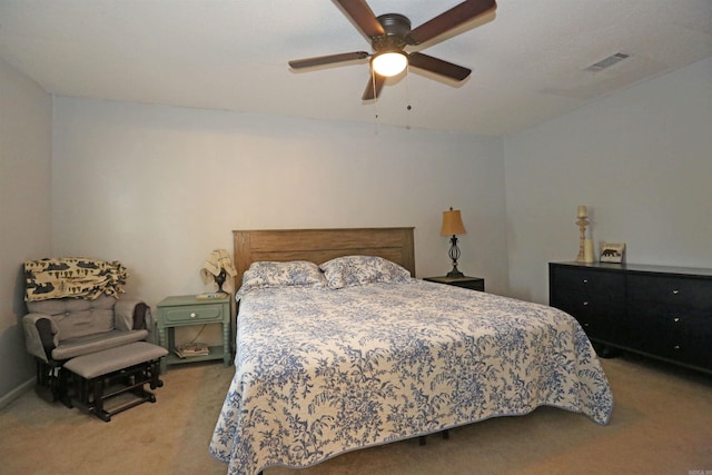 bedroom with a ceiling fan, visible vents, and light colored carpet