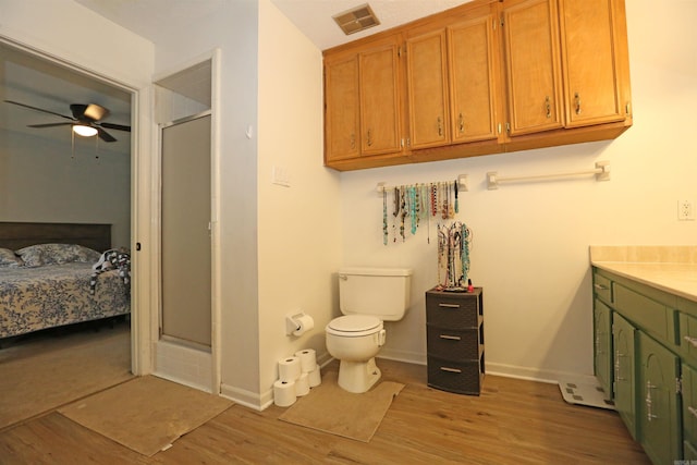 bathroom featuring visible vents, ensuite bathroom, ceiling fan, a shower stall, and wood finished floors