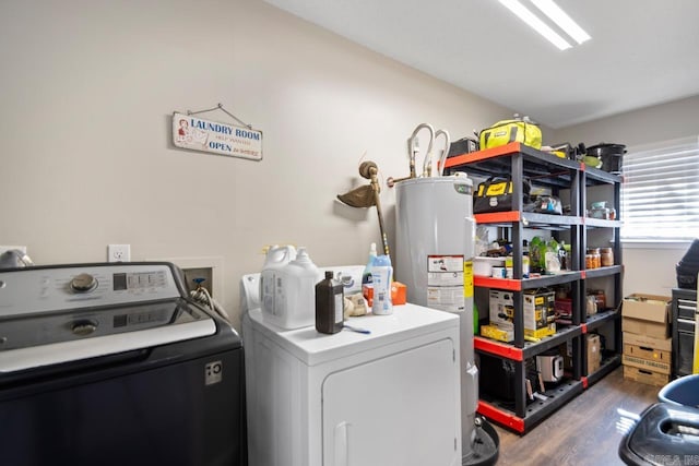 laundry area featuring laundry area, water heater, dark wood-style floors, and washer and dryer